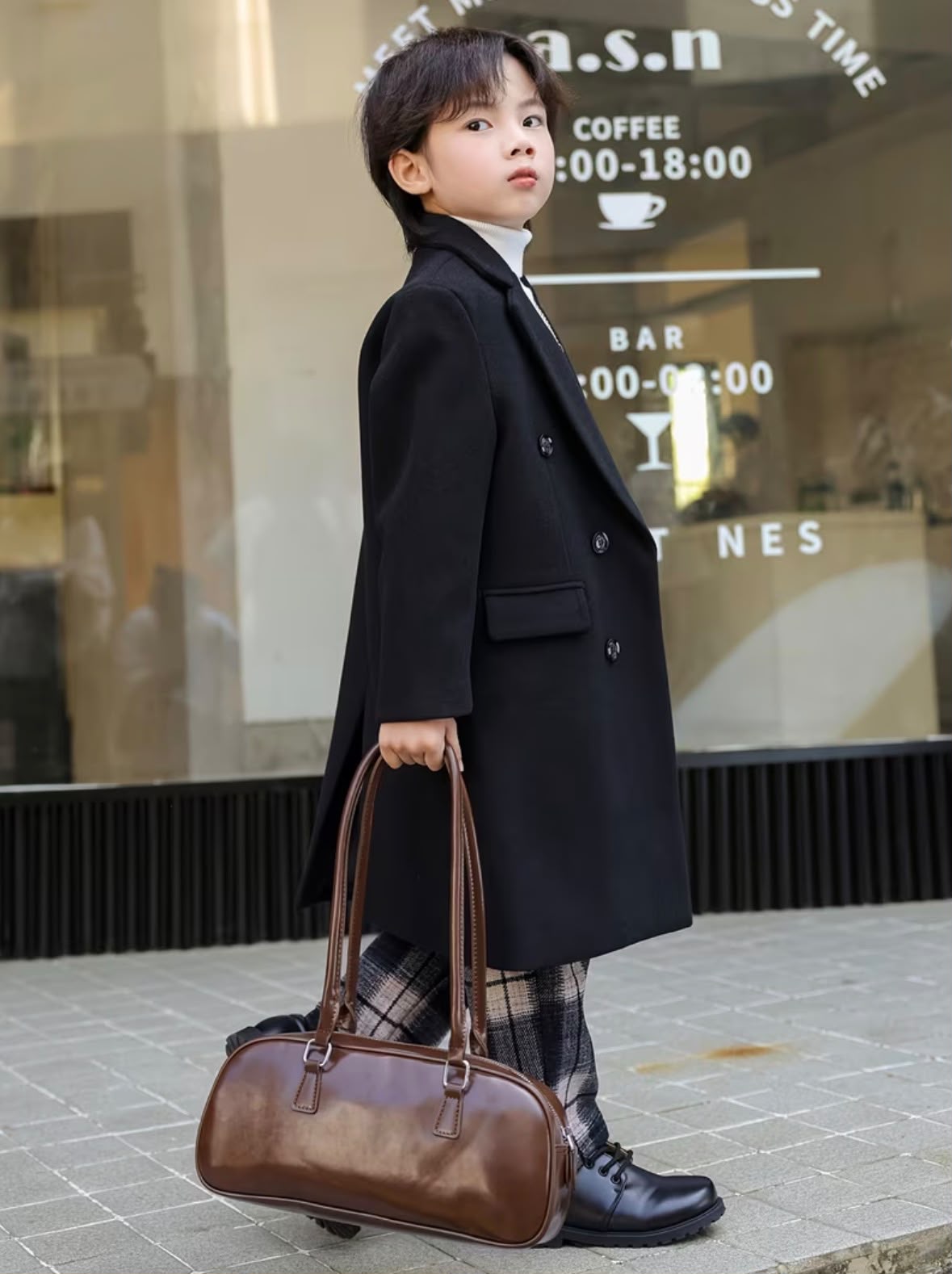 Vintage black trench coat with wide lapels, double buttons, and long length