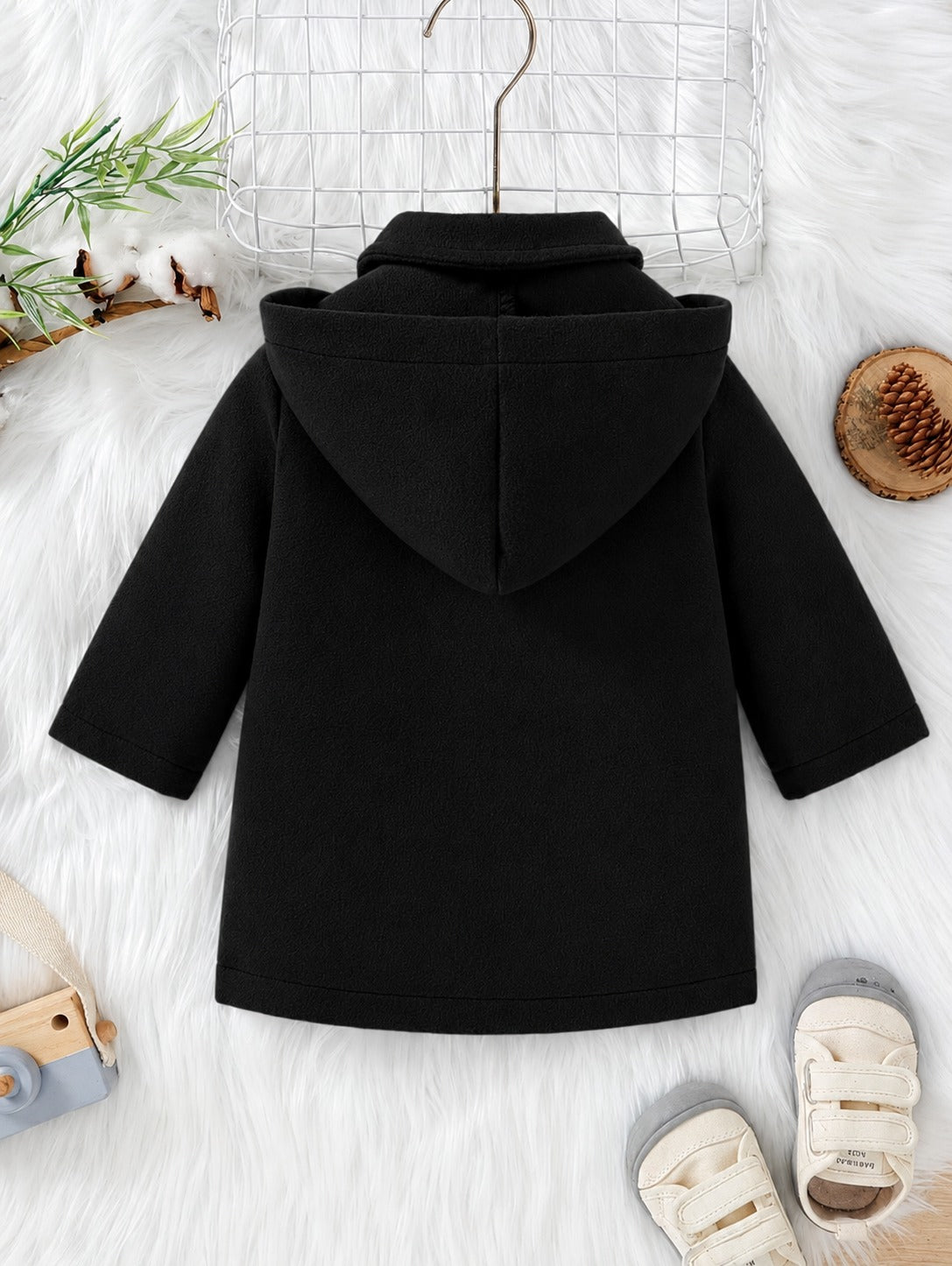Black hooded coat with button front, flap pockets, and folded hood