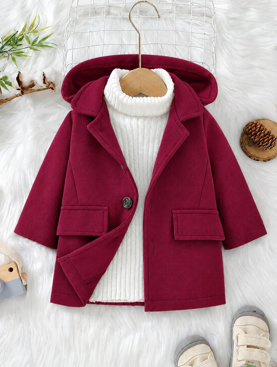 Maroon hooded coat with button front, flap pockets, and folded hood