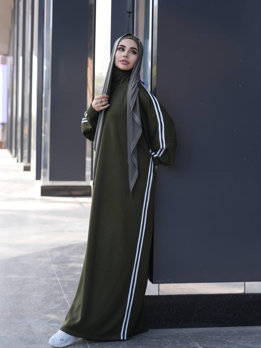 Olive abaya dress with white stripe accents along sleeves and front buttons, paired with black hijab