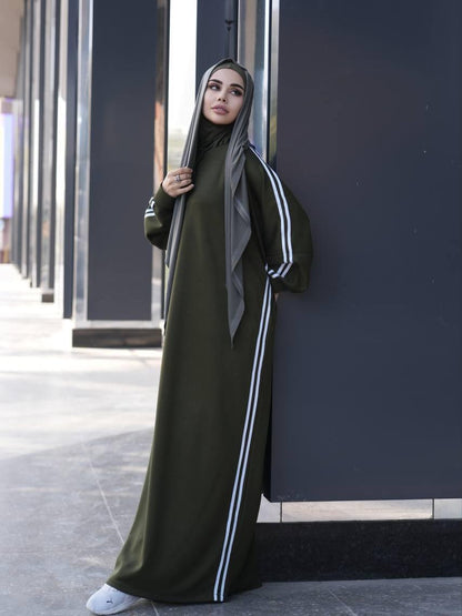 Olive abaya dress with white stripe accents along sleeves and front buttons, paired with black hijab