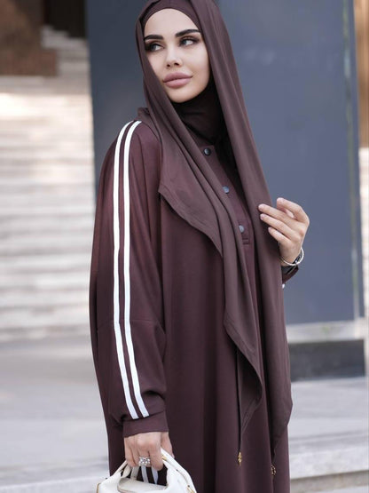 Brown abaya dress with white stripe sleeves, button front, paired with brown hijab