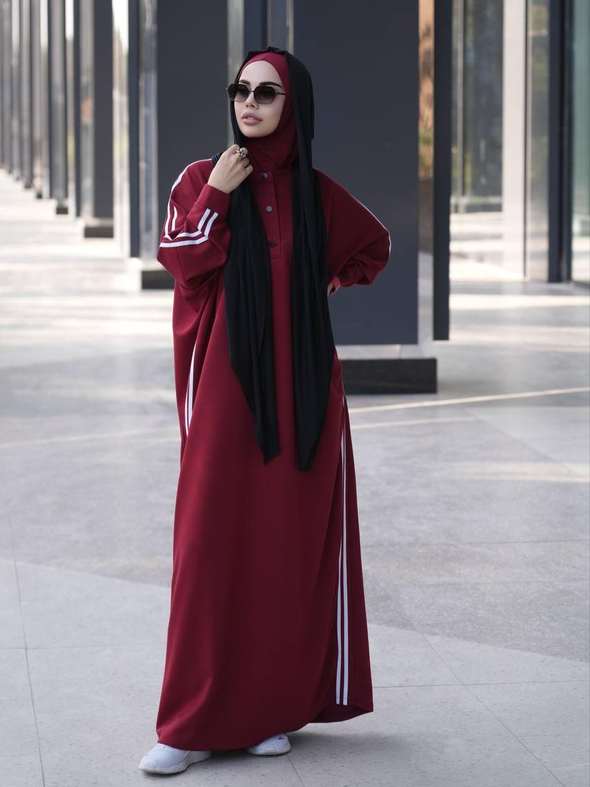 Maroon long abaya dress with button front, striped trim, paired with black hijab