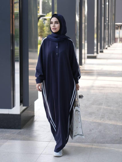 Dark navy long abaya with button front, striped side panels, paired with black hijab