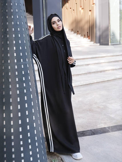 Black long abaya with white stripe trim and black hijab, full-length sleeves