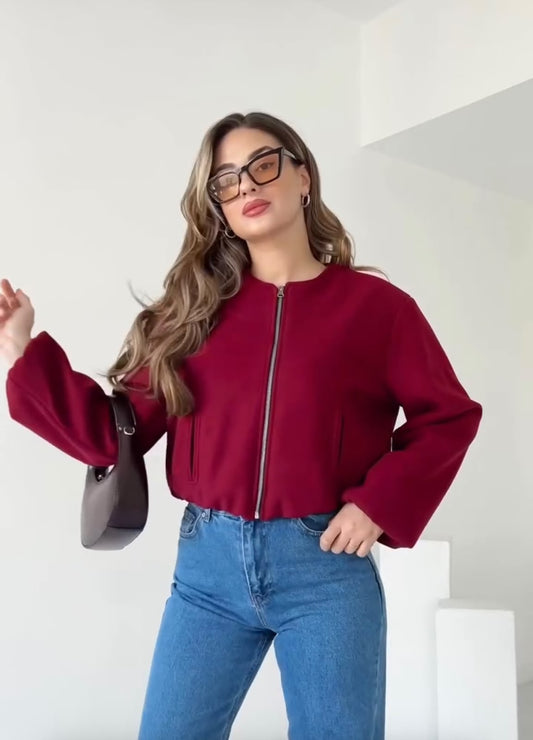 Maroon cropped jacket with front zipper, elastic cuffs, and side pockets
