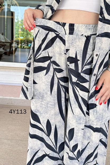 Leaf-print skirt detail of co-ord set, navy and black leaves on light fabric waistband