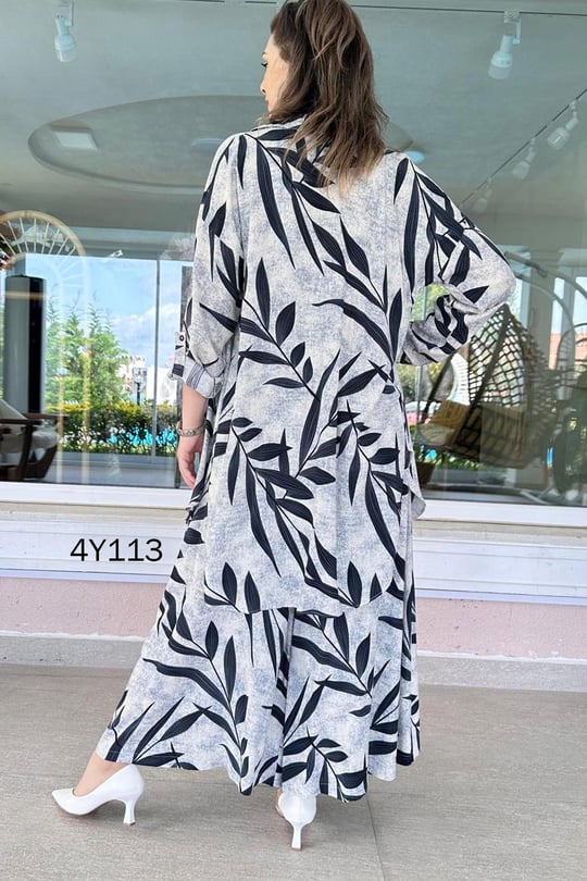 Back view of leaf-print co-ord set, long skirt with navy leaves on light fabric
