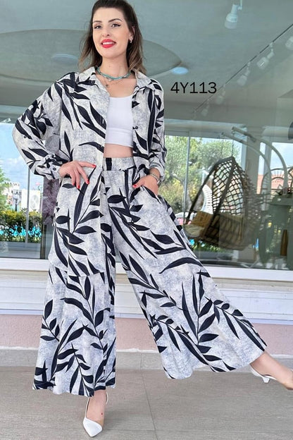 Leaf-print co-ord set with long skirt and open buttoned top, navy leaves on light gray fabric