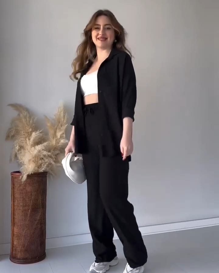 Black 2-piece button co-ord set: open shirt and matching drawstring pants.