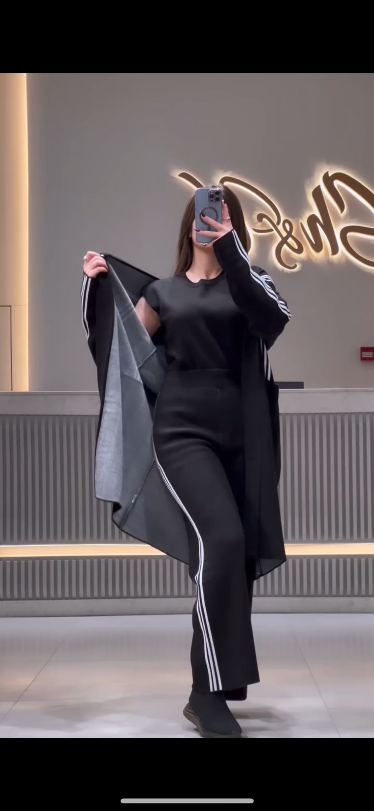 3-piece winter stripe co-ord set in black: long jacket, top, and striped trousers.