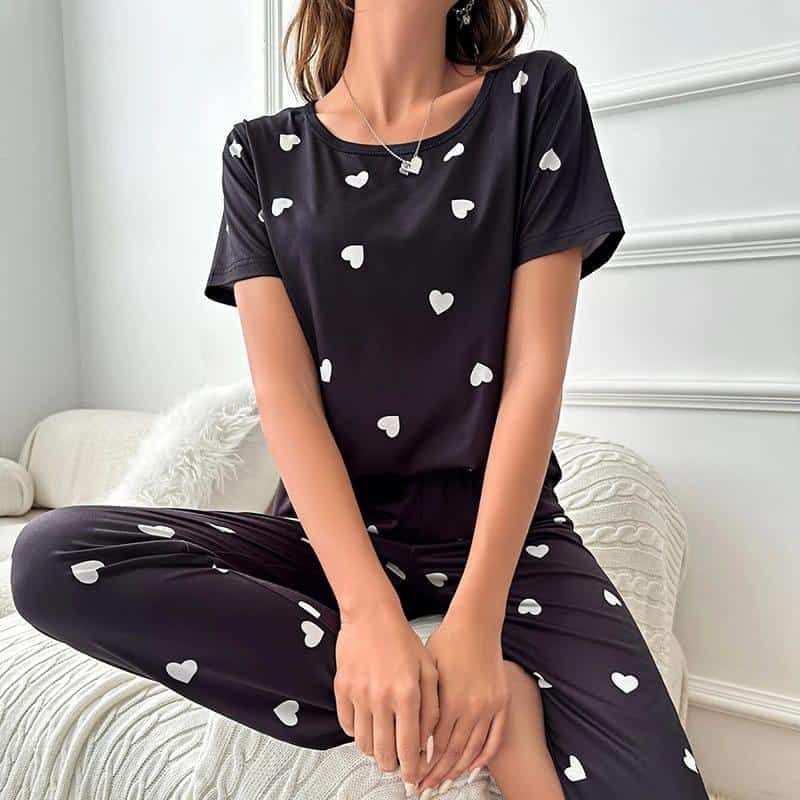 Black pajama set with white heart print, short-sleeve top and relaxed pants