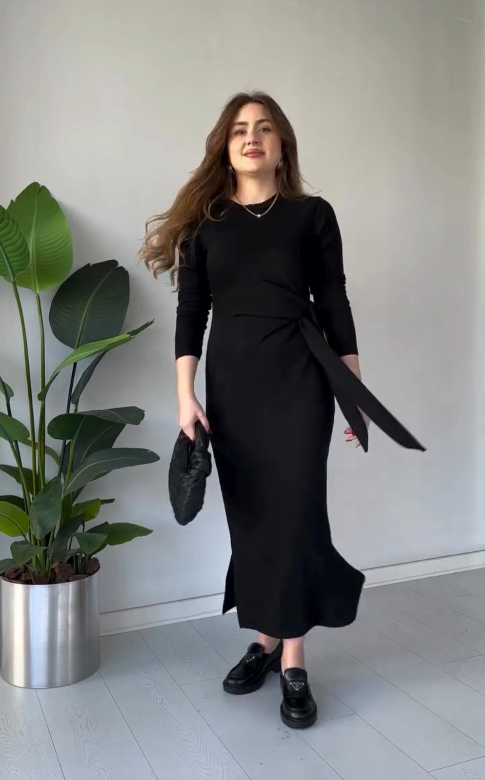 Black modal tie dress with long sleeves, fitted midi silhouette, and side slit