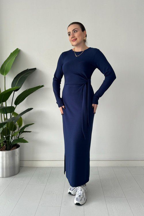 Navy modal tie dress with long sleeves, fitted midi body, and waist tie detail