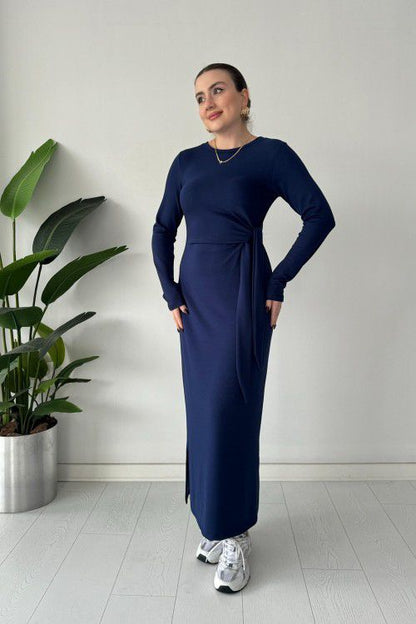 Navy modal tie dress with long sleeves, fitted midi body, and waist tie detail