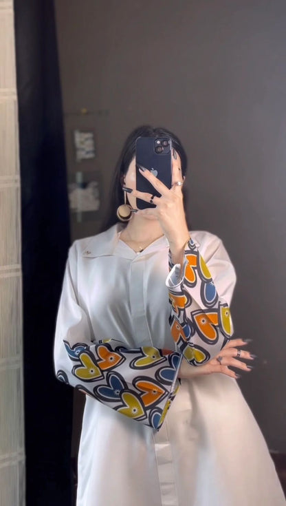 White printed shirt with heart-print accent panels on sleeves; matching palazzo
