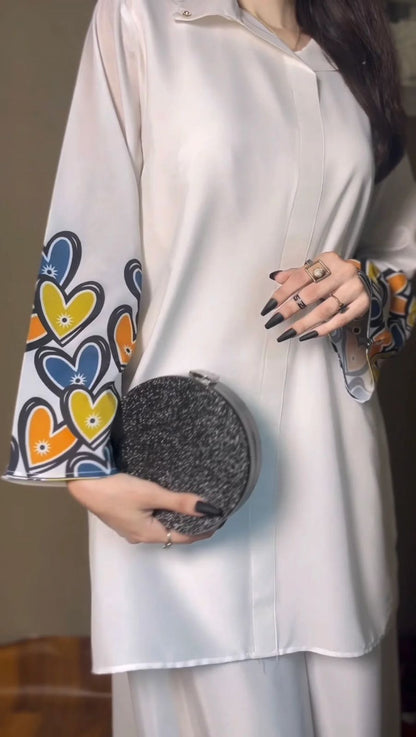 White printed shirt with button placket and heart-print cuff; palazzo hem below