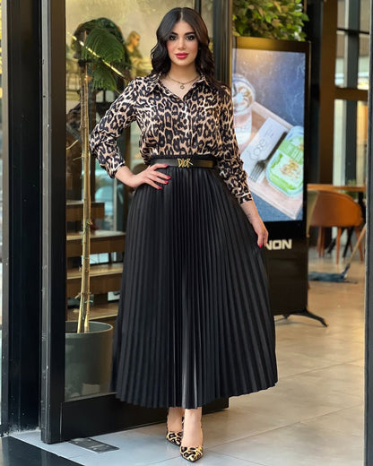 Tiger-print top with black pleated midi skirt and black waist belt