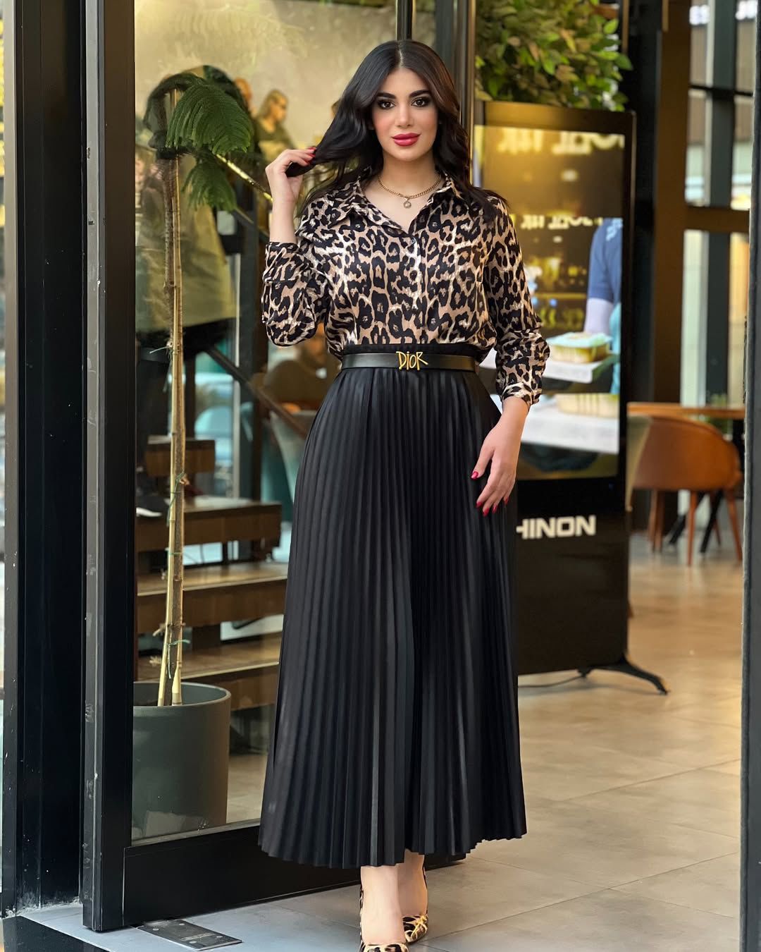 Tiger-print top with black pleated skirt and waist belt, V-neck