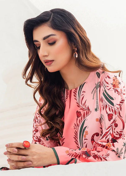 Blush floral printed tunic with long sleeves and neckline trim, close-up