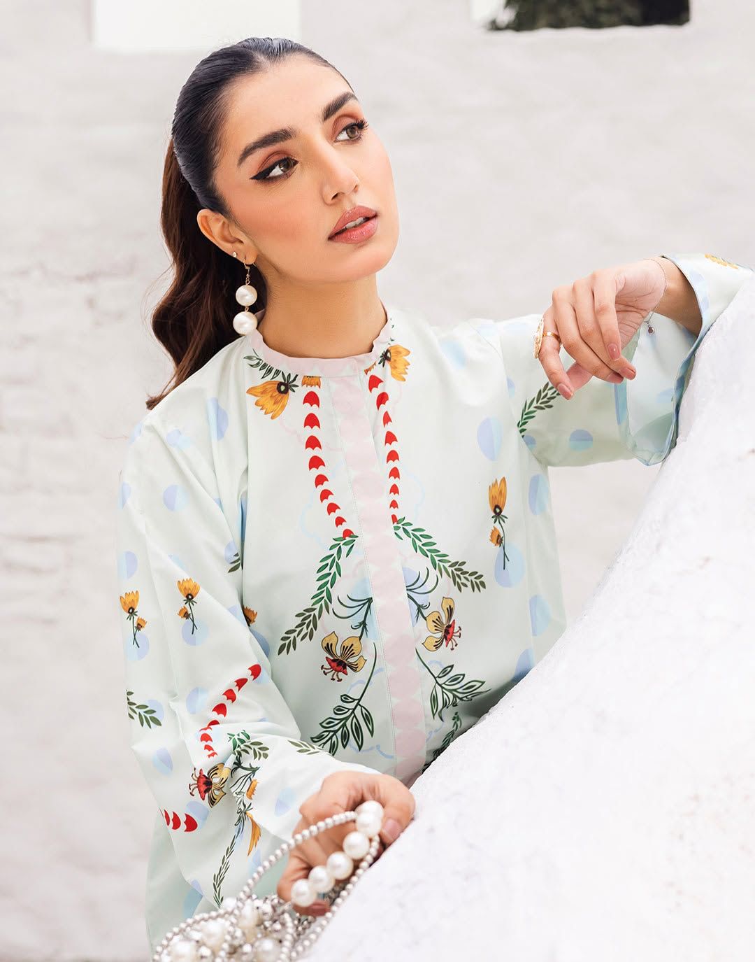 Light blue embroidered kurta with floral motifs and red-green vertical neck detailing
