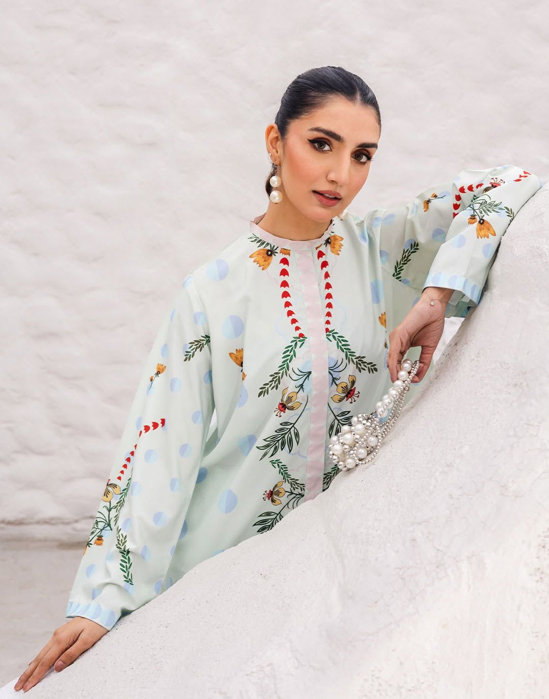 Light blue printed kurta set with floral embroidery, flowing sleeves, and loose fit