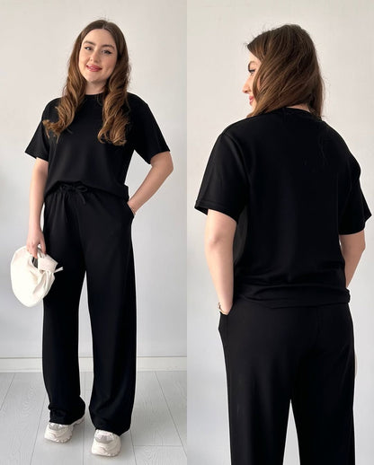 Black two-piece half-sleeve trouser set with tied waist and wide-leg pants