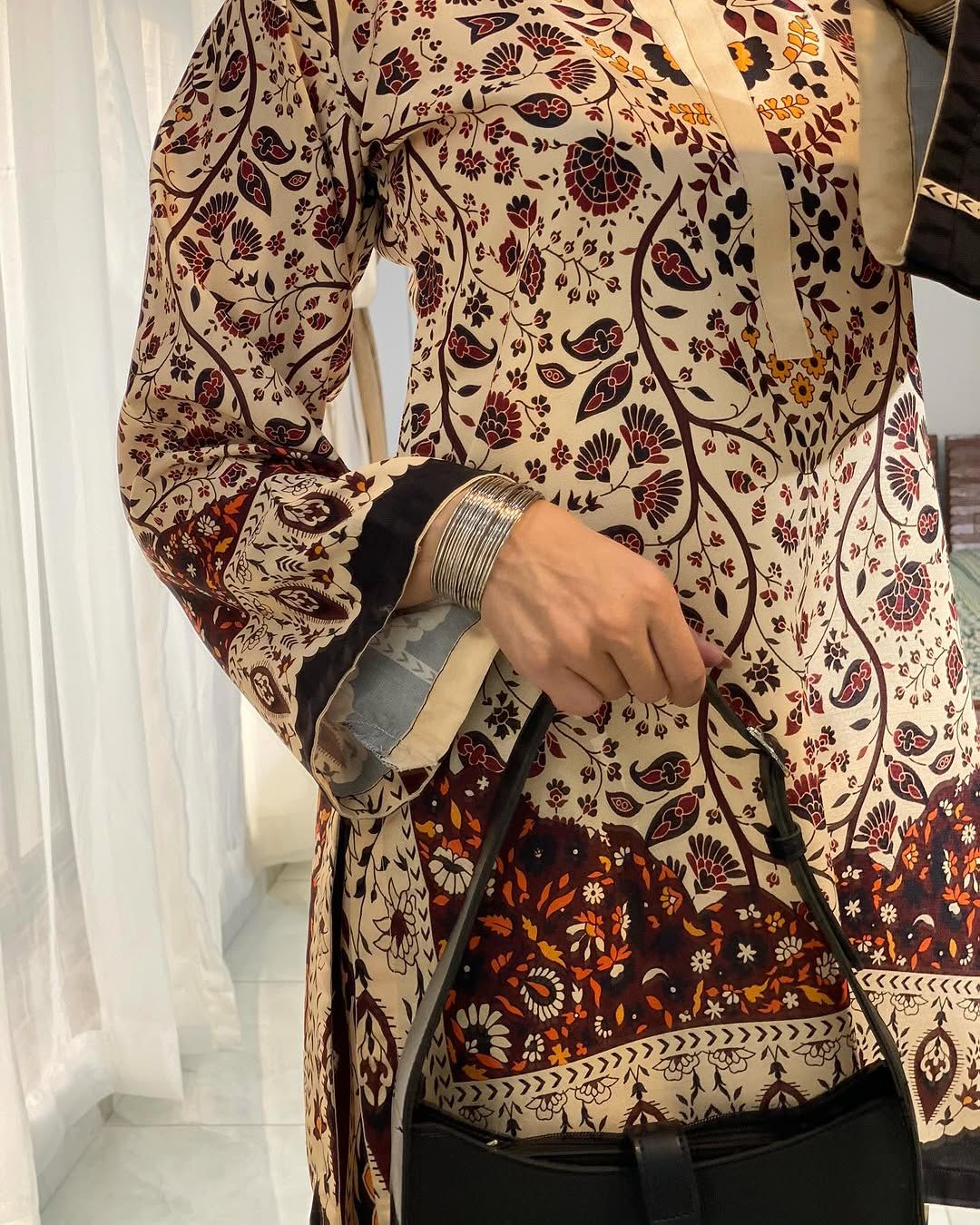 Long printed tunic top with paisley floral pattern and black-trim border detail