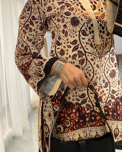 Long printed tunic top with paisley floral pattern and black-trim border detail