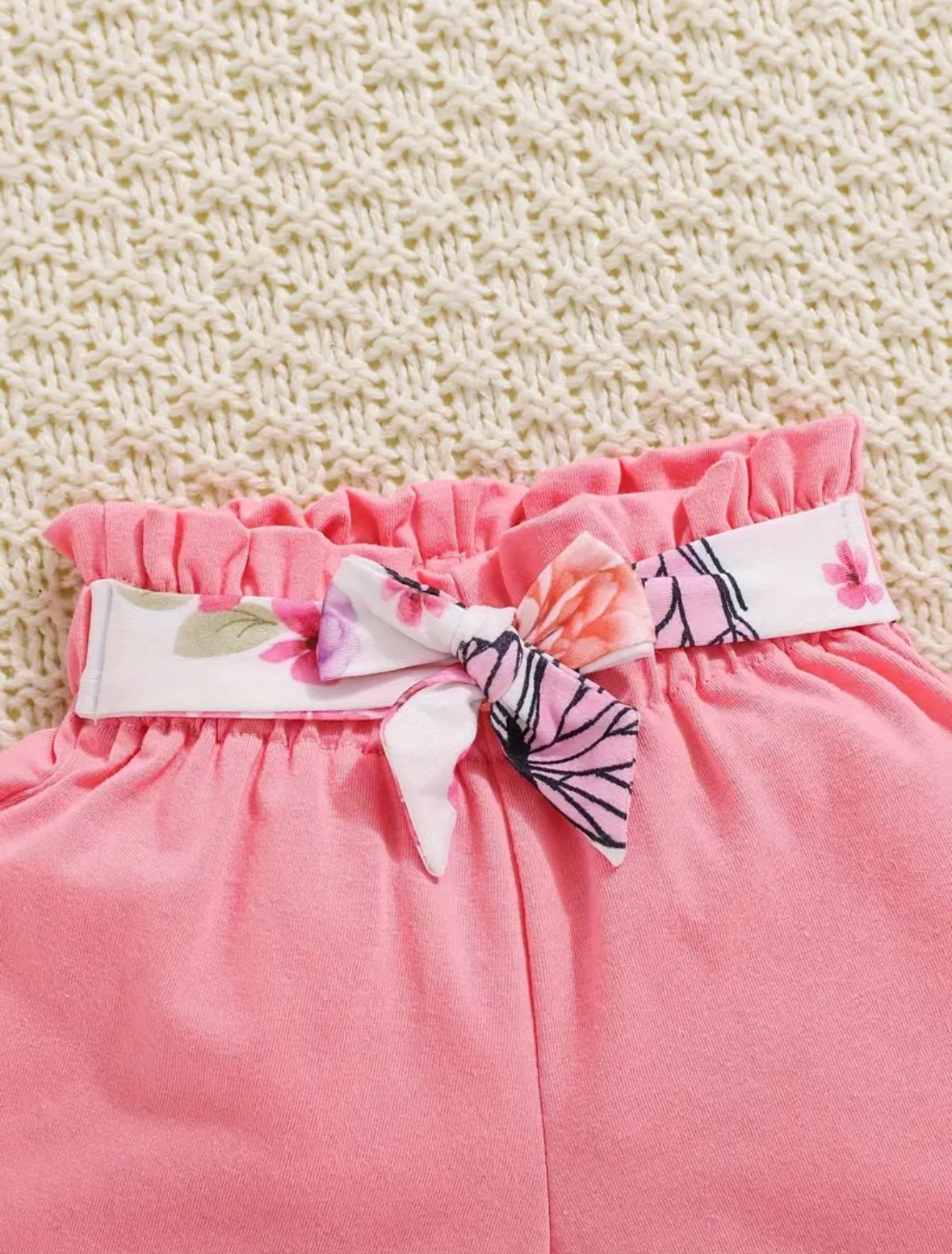 Floral and butterfly print ruffle neckline top with bow and elastic waist hem