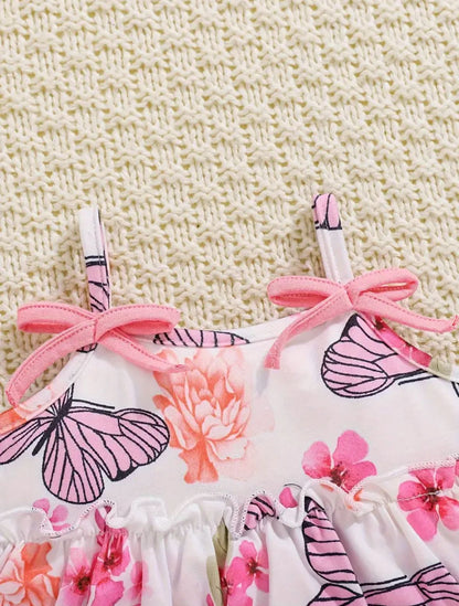 Floral and butterfly print top with pink ribbon shoulder ties and ruffle trim