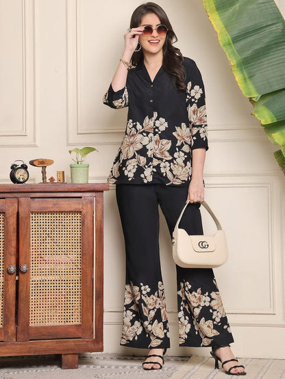 Black floral co-ord set with V-neck blouse and wide-leg trousers, floral border print