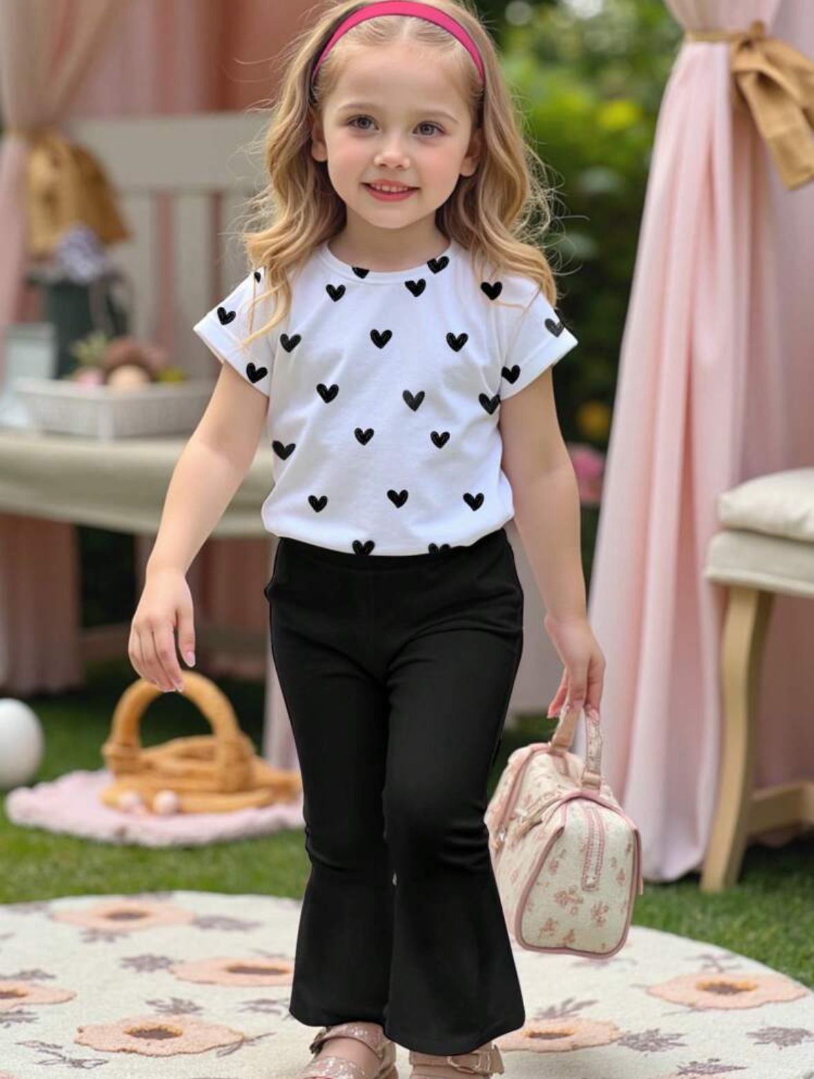Kids two-piece set with white heart-print T-shirt and black flared trousers