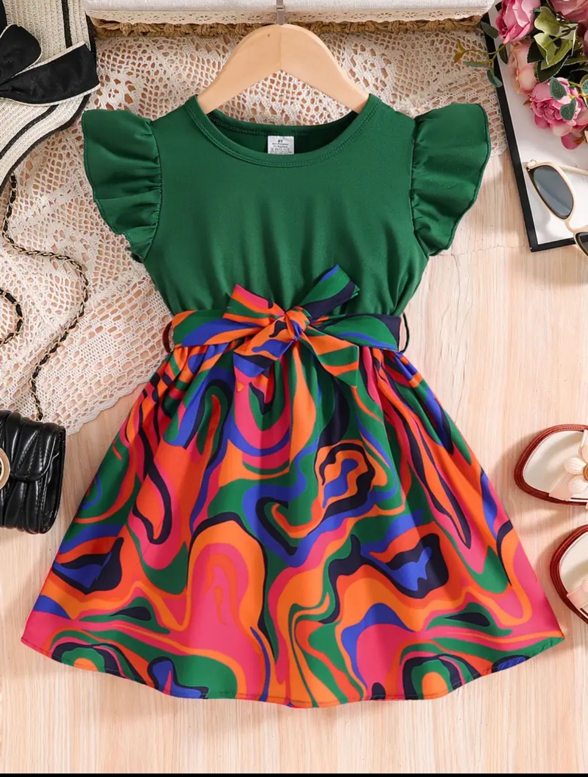Multicolor belted frock dress with green bodice, swirl skirt, and waist bow