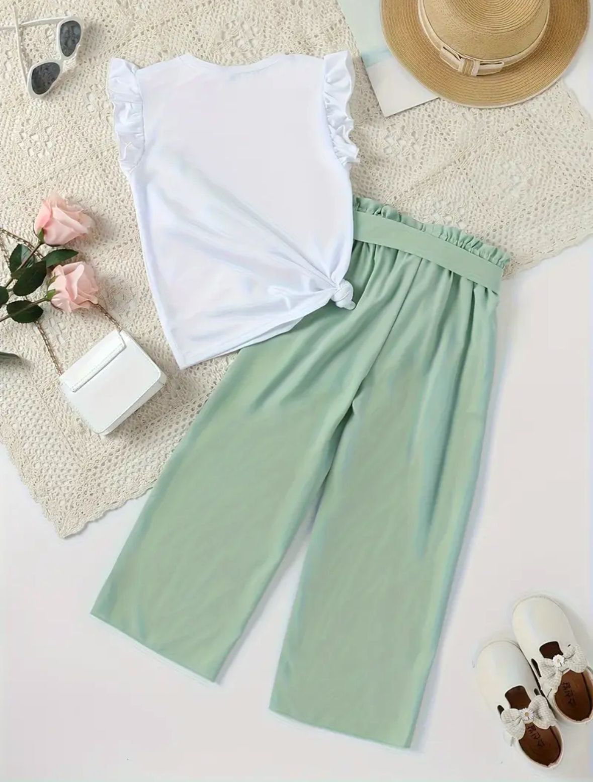 White ruffle-sleeve top and mint-green wide-leg pants with elastic waist