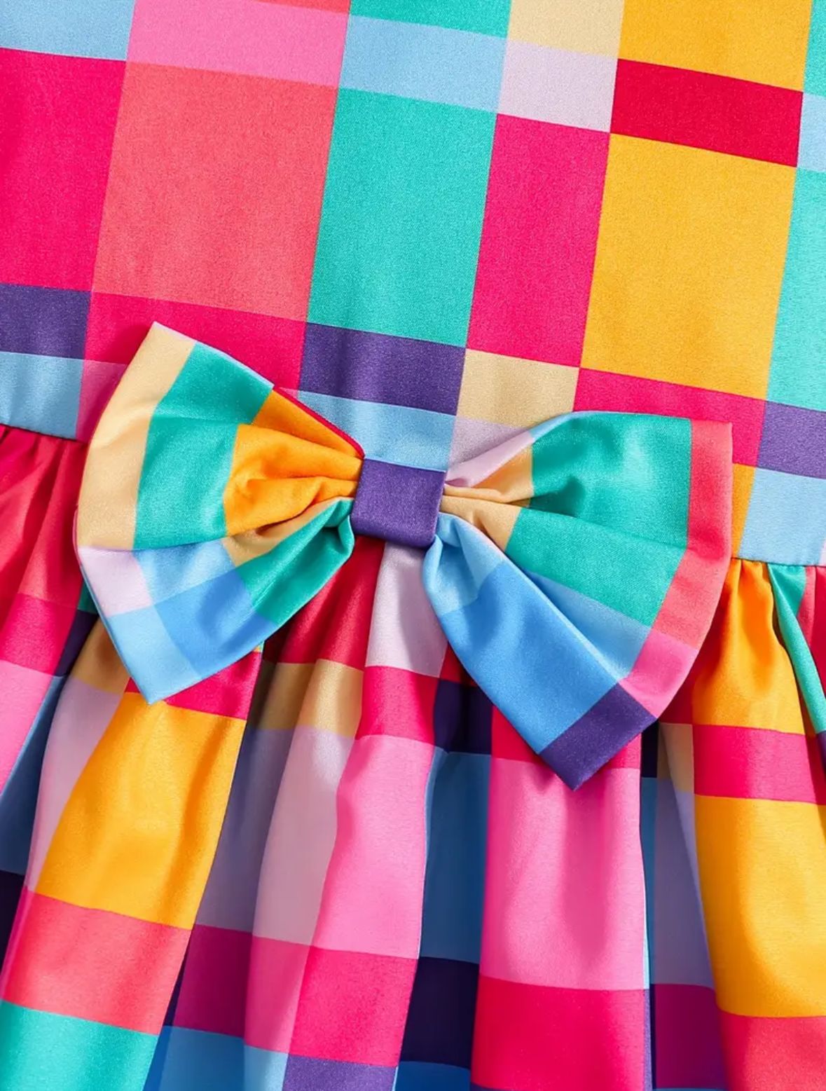 Colorful plaid girls dress with bow at neck, ruffled cuffs