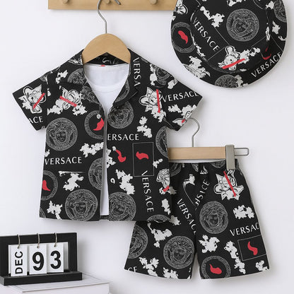 Kids black printed shorts set with VERSACE logo polo shirt and matching shorts on hangers