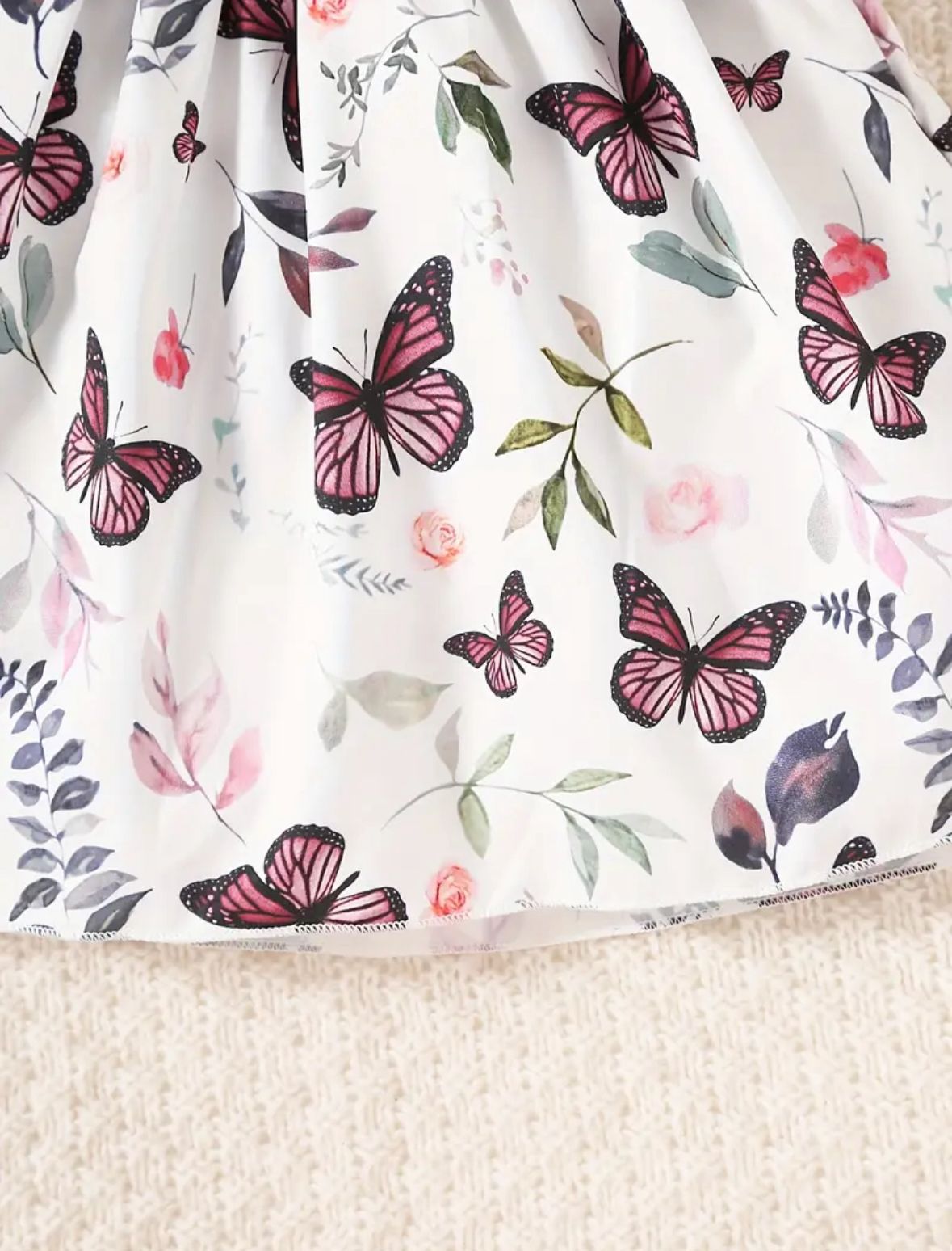 Butterfly print baby dress skirt with red, pink, and dark butterflies on white