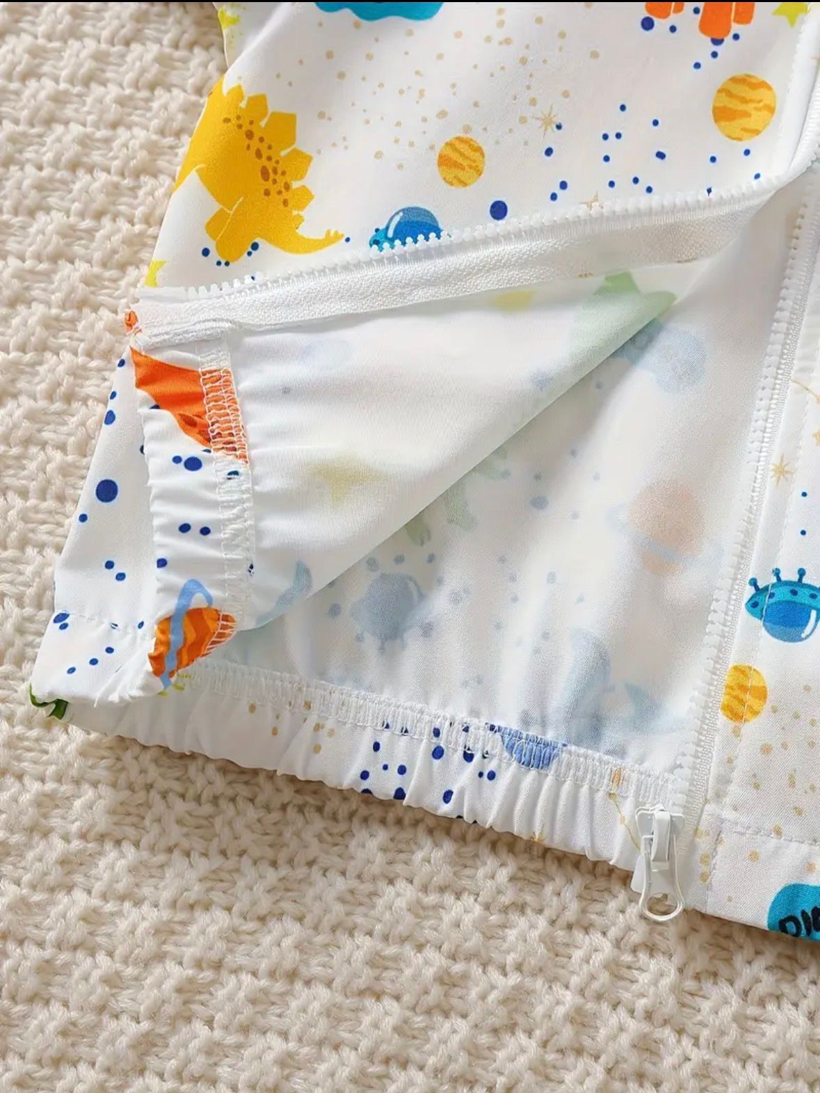Baby white hooded zip-up jacket hem with dinosaur print and elastic cuffs