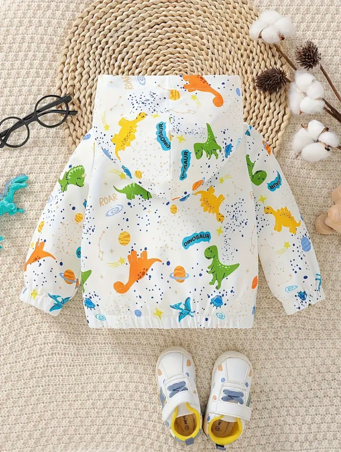 Baby hooded zip-up jacket with colorful dinosaur print and white fabric