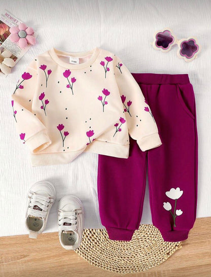 Cream floral sweatshirt with pink sprigs and burgundy pull-on trousers