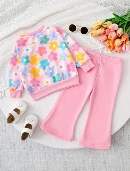 Girls' pastel floral sweatshirt with pink flared trousers, laid flat for detail view