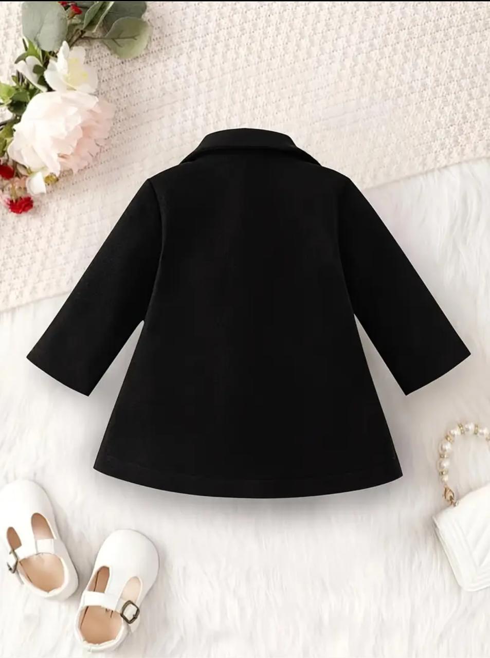 Black coat with wide back yoke and flared sleeves, knee-length