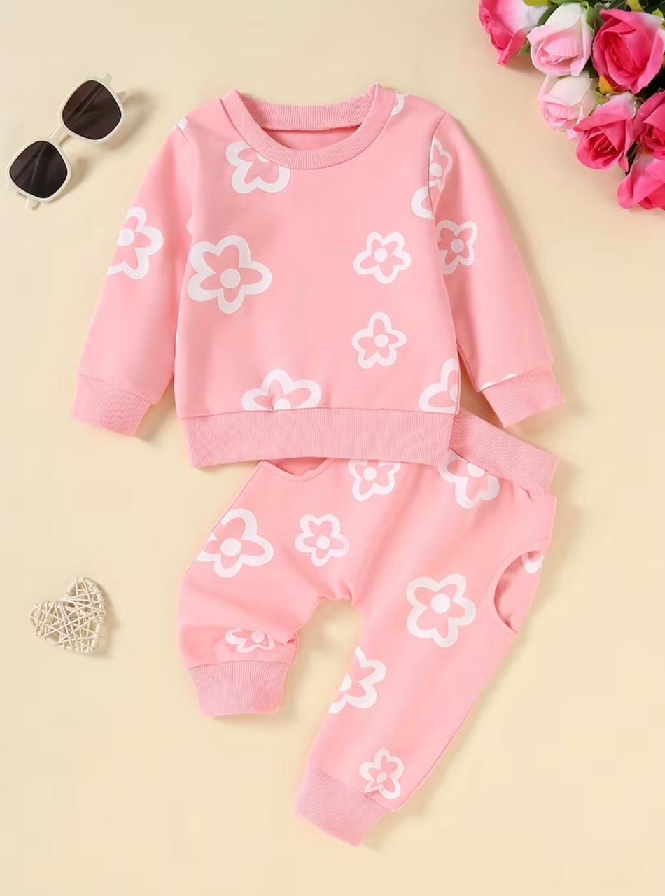 Pink sweatshirt and jogger-style pants set with white flower motifs