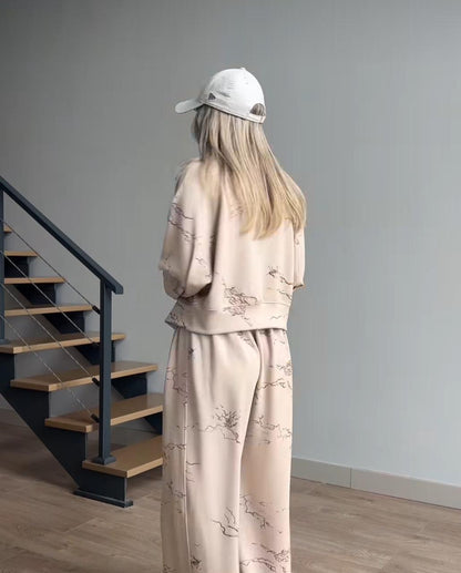 Beige two-piece outfit: satin jacket and wide-leg pants with subtle line pattern