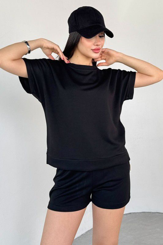 Black crewneck short-sleeve top and drawstring shorts set, arms raised