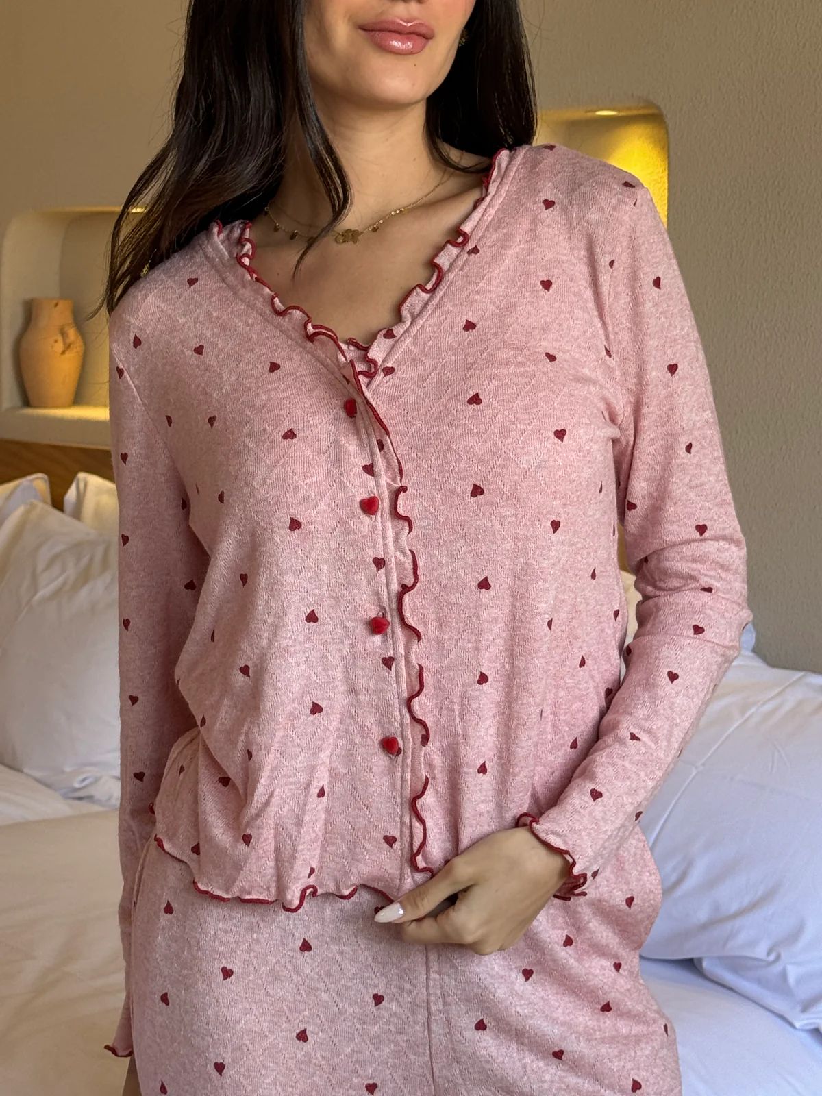 Pink heart-print lounge top with button front, long sleeves, and ruffle trim