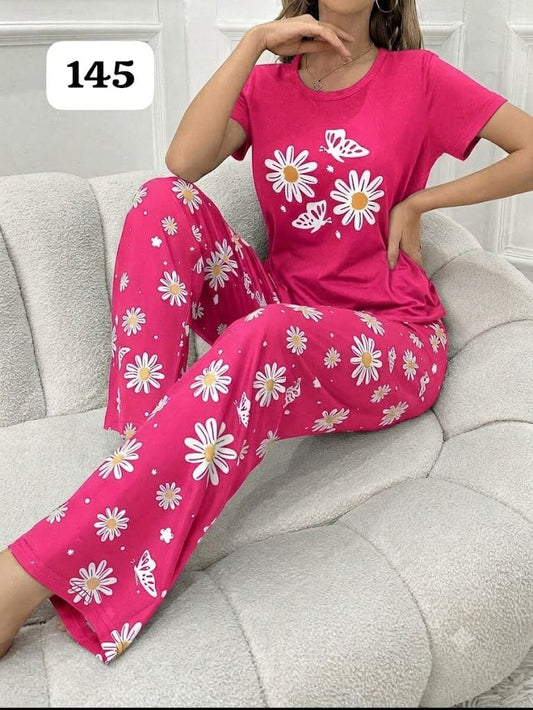 Hot pink short-sleeve pajama set with daisy and butterfly print on pants and T-shirt.