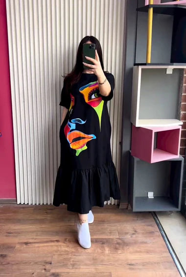 Black printed frill long tee dress with colorful face graphic and ruffled hem