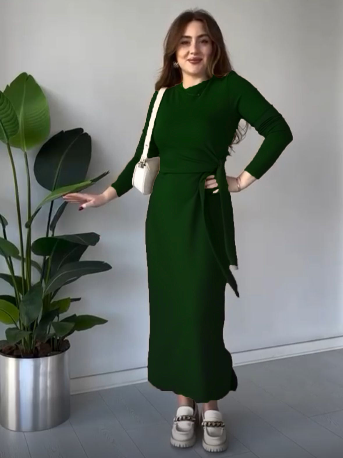 Bottle green modal tie dress with long sleeves, fitted midi silhouette, and waist tie